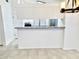 Open kitchen area with breakfast bar featuring granite countertops and tile flooring at 7040 W Olive Ave # 94, Peoria, AZ 85345