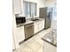 Charming kitchen with granite countertops, stainless steel appliances, and white cabinetry at 7040 W Olive Ave # 94, Peoria, AZ 85345