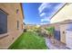 Spacious backyard featuring artificial grass, desert landscaping, and storage for a tidy outdoor space at 710 W Ardmore Rd, Phoenix, AZ 85041