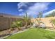 Beautiful backyard with artificial grass, desert landscaping, and a seating area for outdoor relaxation at 710 W Ardmore Rd, Phoenix, AZ 85041