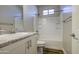 Bright bathroom featuring a tub shower, granite countertop and white cabinetry at 710 W Ardmore Rd, Phoenix, AZ 85041