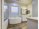 Spa-like bathroom featuring a soaking tub, separate shower, and double vanity at 710 W Ardmore Rd, Phoenix, AZ 85041