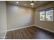 Bright bedroom with wood-look floors and a view of the greenery outside at 710 W Ardmore Rd, Phoenix, AZ 85041