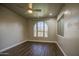 Empty bedroom with wood-look flooring, large window, and a ceiling fan at 710 W Ardmore Rd, Phoenix, AZ 85041