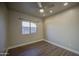 Neutral bedroom with ceiling fan, window and wood-look flooring at 710 W Ardmore Rd, Phoenix, AZ 85041