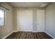 A spacious bedroom with wood-look flooring and closet with sliding doors at 710 W Ardmore Rd, Phoenix, AZ 85041