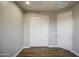 Bright bedroom with wood-look flooring, a closet and white doors at 710 W Ardmore Rd, Phoenix, AZ 85041