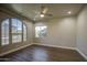 A bedroom with a ceiling fan and large windows with a view outside at 710 W Ardmore Rd, Phoenix, AZ 85041