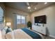 A stylish bedroom with a ceiling fan, accent wall art and a white storage cabinet at 710 W Ardmore Rd, Phoenix, AZ 85041