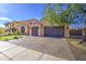 Charming home featuring a paver driveway, two-car garage, and manicured front yard, set against a clear blue sky at 710 W Ardmore Rd, Phoenix, AZ 85041