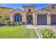 Inviting home showcasing a manicured lawn, stone accents, and a charming arched entrance, perfect for a Gathering at 710 W Ardmore Rd, Phoenix, AZ 85041