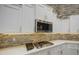 Stylish kitchen featuring white cabinets, quartz countertops, and stainless steel appliances at 710 W Ardmore Rd, Phoenix, AZ 85041