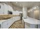 Spacious kitchen with white cabinetry, stainless steel appliances, and pendant lighting fixtures at 710 W Ardmore Rd, Phoenix, AZ 85041