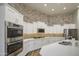 A modern kitchen with stainless appliances, white cabinets and a large island for entertaining at 710 W Ardmore Rd, Phoenix, AZ 85041