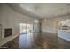 Living room with a fireplace and views of the outdoor pool from large glass sliding doors at 710 W Ardmore Rd, Phoenix, AZ 85041