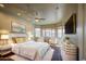 Bright main bedroom boasts large windows, ceiling fan, and a comfortable seating area at 710 W Ardmore Rd, Phoenix, AZ 85041