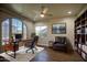 A home office featuring a built in bookshelf, a ceiling fan, and a view outside at 710 W Ardmore Rd, Phoenix, AZ 85041