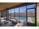 Screened patio showcasing comfortable seating overlooking the beautiful pool and backyard at 710 W Ardmore Rd, Phoenix, AZ 85041