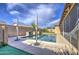Backyard pool surrounded by a patio, shaded by two umbrellas, in a secluded backyard at 710 W Ardmore Rd, Phoenix, AZ 85041
