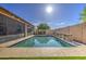 Sparkling pool features a tile-lined edge, stone features, and well-manicured surrounding landscape at 710 W Ardmore Rd, Phoenix, AZ 85041