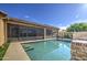 Backyard pool surrounded by a patio, screened in outdoor space, with grass and patio at 710 W Ardmore Rd, Phoenix, AZ 85041