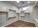 Spacious walk-in closet with custom shelving, wooden racks and wood-look floors at 710 W Ardmore Rd, Phoenix, AZ 85041