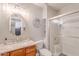 Bright bathroom with a white countertop sink, decorative mirror, and a glass-enclosed shower at 7940 W Willow Ave, Peoria, AZ 85381