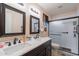 Elegant bathroom with a dual sink vanity, framed mirrors, and glass enclosed shower at 7940 W Willow Ave, Peoria, AZ 85381