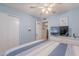 Bedroom featuring a ceiling fan, closet, and adjacent sitting area with natural light at 7940 W Willow Ave, Peoria, AZ 85381