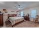 Traditional bedroom with a cozy quilt, dark wood furniture, and natural light from two windows at 7940 W Willow Ave, Peoria, AZ 85381