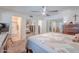 Bedroom with a bed, and sliding mirrored closet, leading to a bathroom at 7940 W Willow Ave, Peoria, AZ 85381