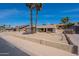 Charming single-story home featuring desert landscaping, a two-car garage, and mature trees accenting the front yard at 7940 W Willow Ave, Peoria, AZ 85381