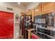 Kitchen with wooden cabinets, stainless steel appliances and a red accent wall at 7940 W Willow Ave, Peoria, AZ 85381