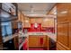 Kitchen featuring wooden cabinets, stainless steel appliances, and a red accent wall at 7940 W Willow Ave, Peoria, AZ 85381