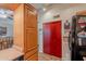 Traditional-style kitchen with light wood cabinets, adjacent to dining area, with red storage closet at 7940 W Willow Ave, Peoria, AZ 85381