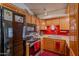 Kitchen with oak cabinets, stainless steel appliances, and a red accent wall at 7940 W Willow Ave, Peoria, AZ 85381