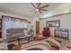 Cozy living room featuring a ceiling fan, plush furniture, and a decorative rug at 7940 W Willow Ave, Peoria, AZ 85381