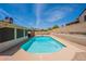 Backyard swimming pool with lounge area, blue water, and privacy wall perfect for relaxation at 7940 W Willow Ave, Peoria, AZ 85381
