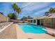 Relaxing backyard featuring a diving board, swimming pool, and ample space for outdoor activities at 7940 W Willow Ave, Peoria, AZ 85381