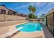 Backyard view with pool, diving board, rock landscaping, and privacy walls at 7940 W Willow Ave, Peoria, AZ 85381