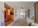 Open sun room features neutral carpet, a ceiling fan, and access to the kitchen and backyard at 7940 W Willow Ave, Peoria, AZ 85381