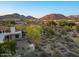 Scenic aerial view of backyard landscaping and neighboring houses with mountains in the distance at 8540 E Mcdowell Rd # 119, Mesa, AZ 85207