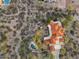 Overhead shot of house with orange tile roof, a desert landscape, and outdoor pool at 8540 E Mcdowell Rd # 119, Mesa, AZ 85207