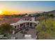 Majestic aerial view of desert home with covered patio and brick courtyard at sunset at 8540 E Mcdowell Rd # 119, Mesa, AZ 85207