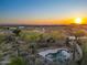 Bird's-eye view of a house with terracotta roof, pool, desert landscaping, and sunset sky at 8540 E Mcdowell Rd # 119, Mesa, AZ 85207