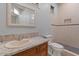 Updated bathroom featuring a vanity, framed mirror, toilet, and tiled walk-in shower at 8540 E Mcdowell Rd # 119, Mesa, AZ 85207
