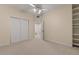 Neutral bedroom with closet, shelving and doorway to an adjacent space, carpeted throughout at 8540 E Mcdowell Rd # 119, Mesa, AZ 85207