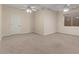 Spacious bedroom with neutral walls, carpet, a door and bright overhead lighting and a window at 8540 E Mcdowell Rd # 119, Mesa, AZ 85207