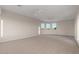 The bonus room has carpeted floors, neutral paint, ceiling fans and multi-pane windows at 8540 E Mcdowell Rd # 119, Mesa, AZ 85207