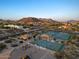 Community aerial view featuring tennis and basketball courts, playground, and mountain views at 8540 E Mcdowell Rd # 119, Mesa, AZ 85207